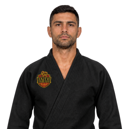 Man in Jiu Jutsu Black Gi wearing a red and yellow Christian themed patch