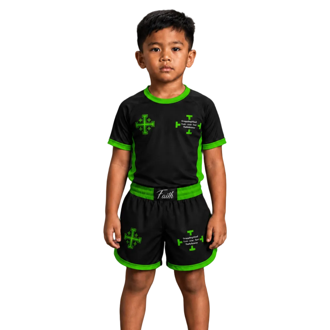 A young boy stands barefoot against a dark studio background wearing a black short-sleeve athletic shirt and matching shorts with bright green trim and green cross graphics. Large white text reads FRONT, and the top left shows The Reverence and GREEN COLORWAY.