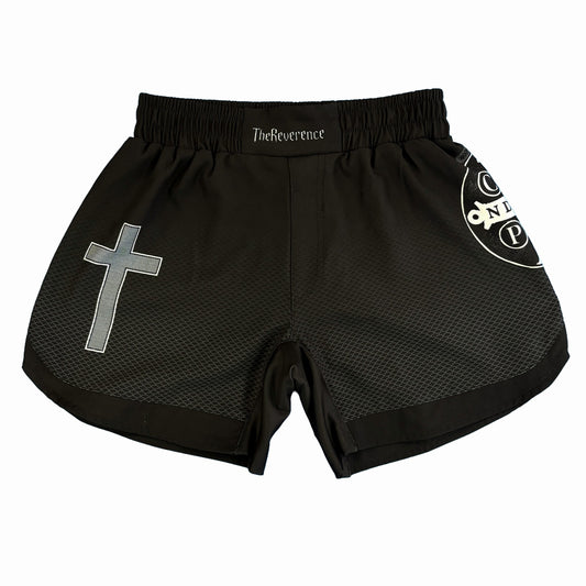 Black athletic shorts with a cross design and branding on a white background