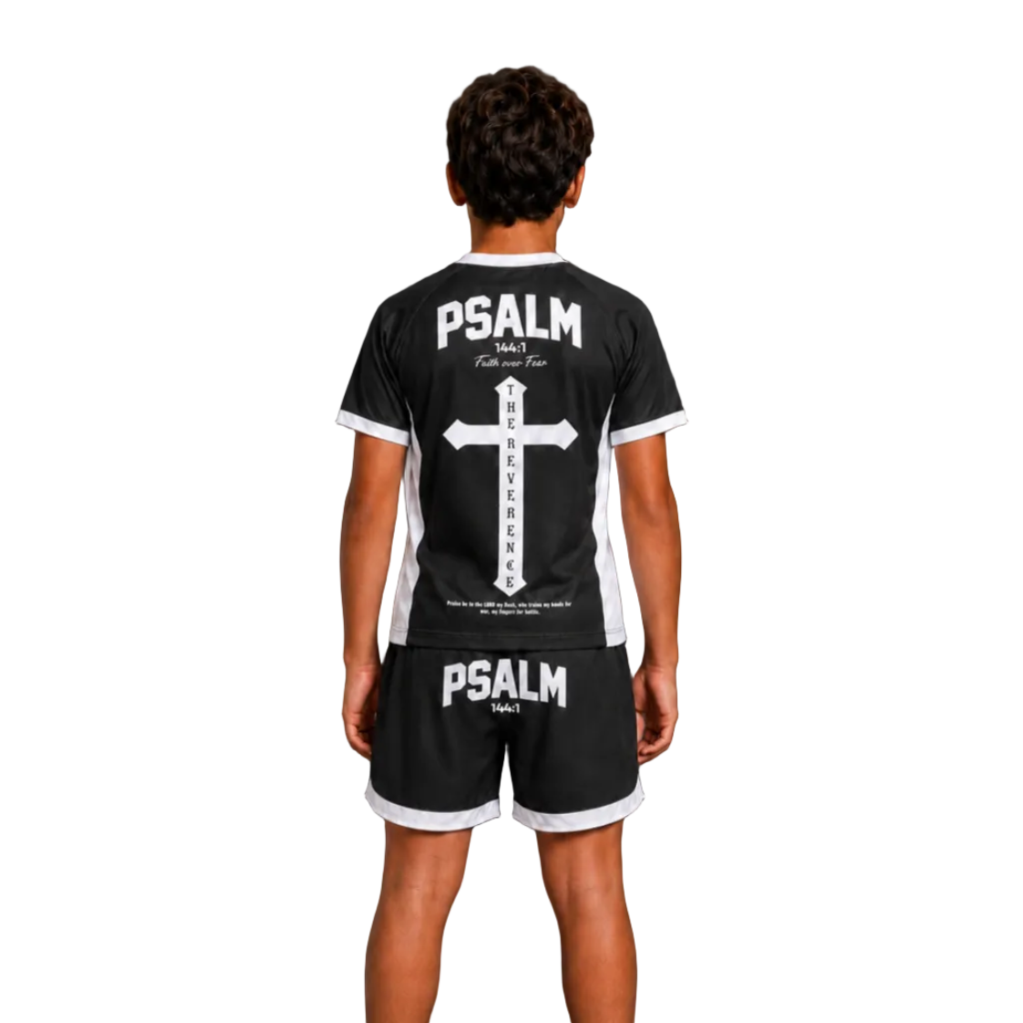 A man stands barefoot against a dark studio background wearing a black short-sleeve athletic jersey and matching shorts, shown from the back. The apparel has white trim and large white 'PSALM' text with a cross graphic on the jersey and 'PSALM' text on the shorts.