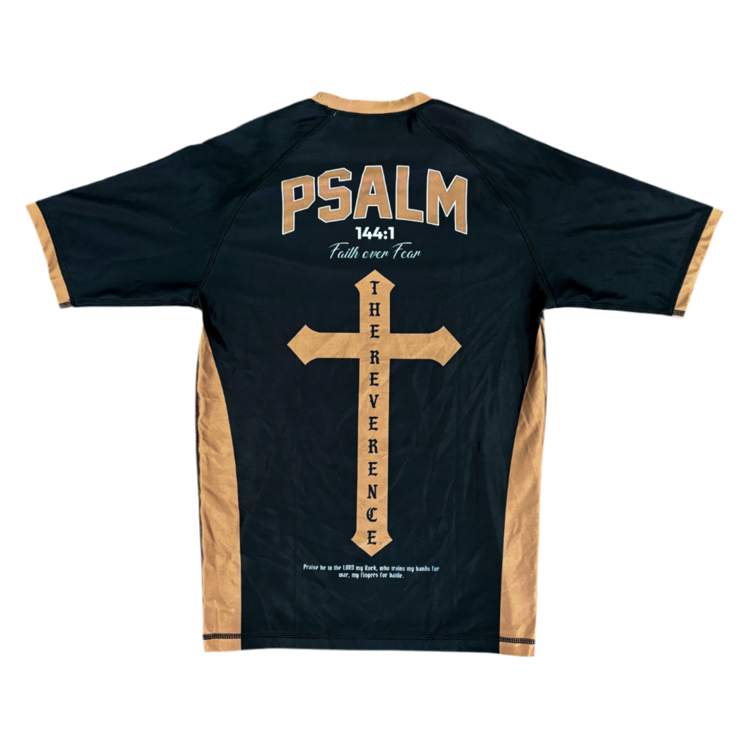 Black t-shirt with beige cross design and text on a white background