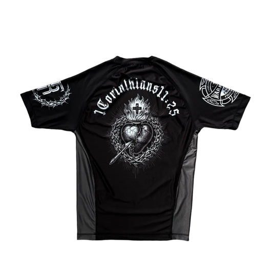 Black t-shirt with white graphic design on a wooden surface