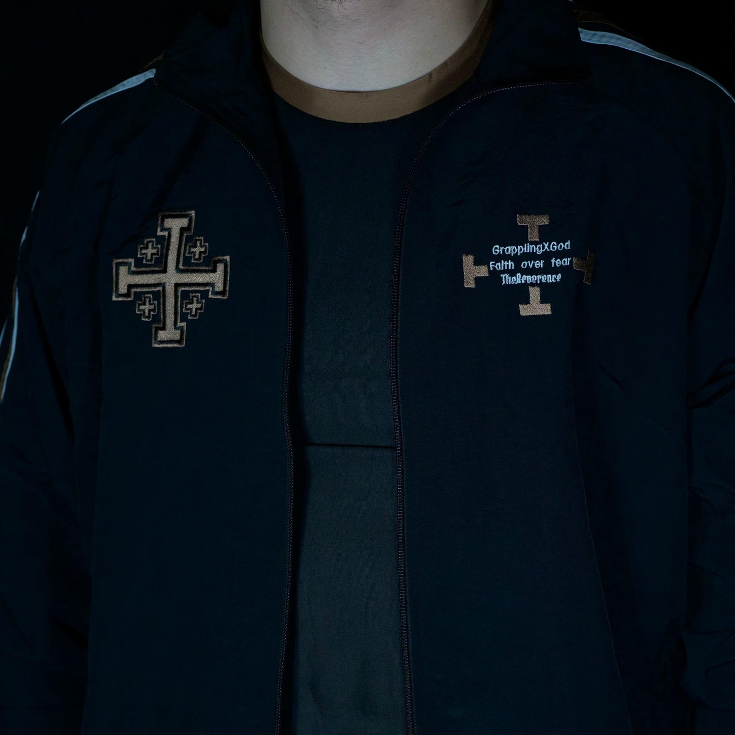 Dark jacket with embroidered designs on a black background
