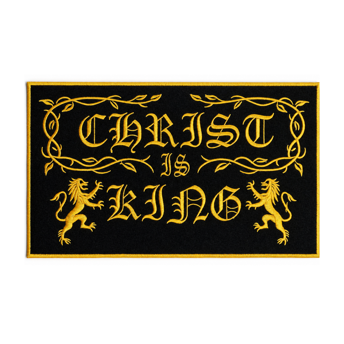 A rectangular black doormat with a gold border and the phrase 'CHRIST IS KING' in ornate gold lettering, flanked by two gold lions, shown on a plain white background.
